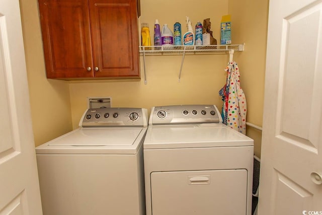 laundry area featuring independent washer and dryer and cabinets