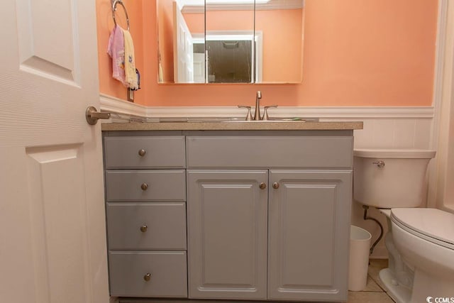 bathroom featuring vanity, toilet, and tile patterned floors