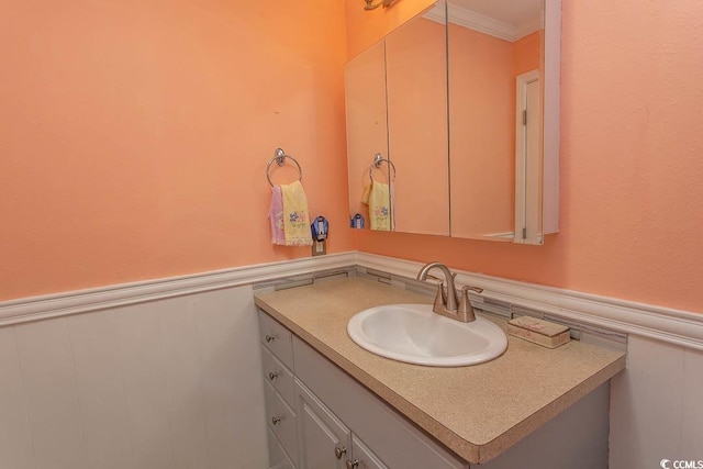 bathroom with crown molding and vanity