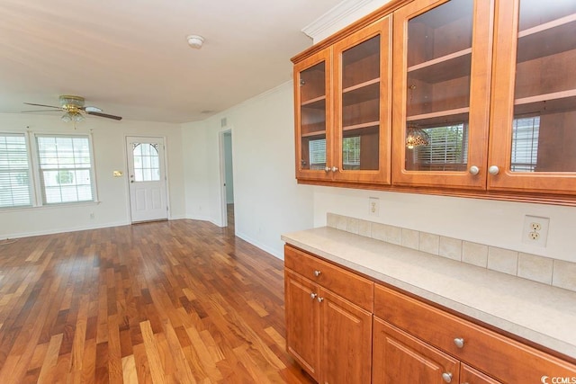 340 Walden Lake Rd, Conway, SC 29526 - kitchen featuring brown cabinetry, dark wood-style floors, ceiling fan, baseboards, and crown molding