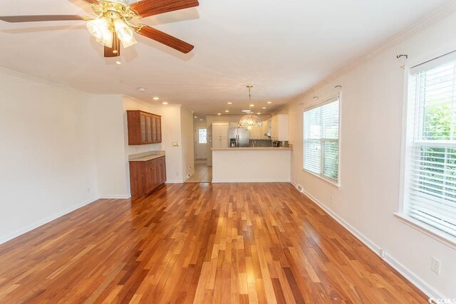 340 Walden Lake Rd, Conway, SC 29526 - unfurnished living room featuring light wood finished floors, crown molding, ceiling fan, recessed lighting, and baseboards