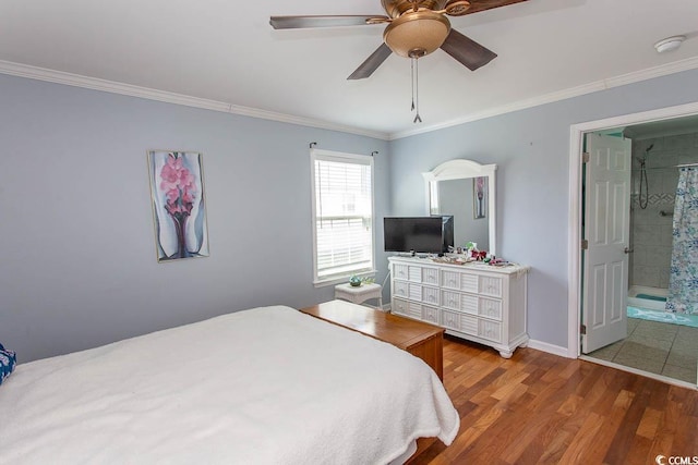 bedroom featuring ceiling fan, connected bathroom, hardwood / wood-style floors, and crown molding