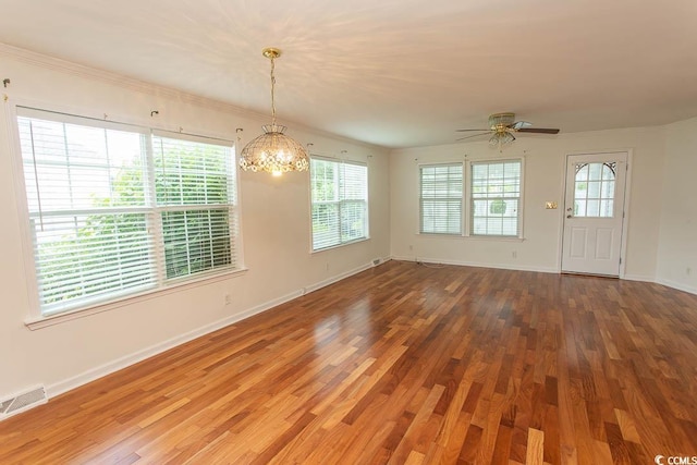 340 Walden Lake Rd, Conway, SC 29526 - empty room with wood finished floors, a chandelier, a ceiling fan, baseboards, and ornamental molding