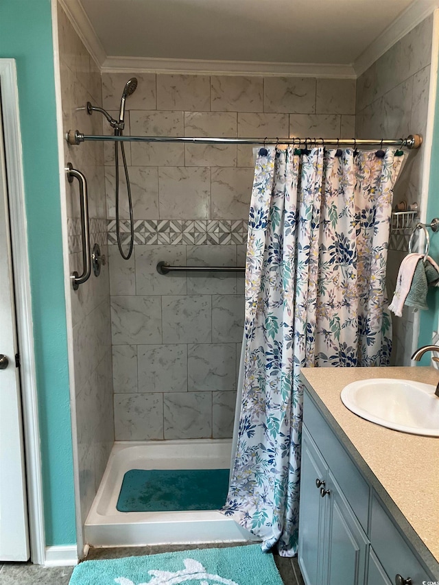 bathroom with crown molding, vanity, and walk in shower