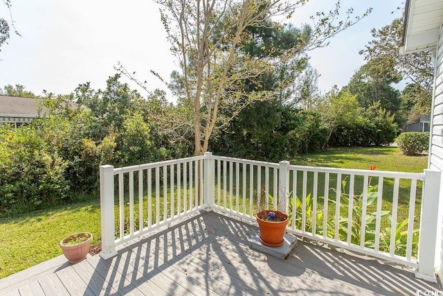 wooden terrace featuring a yard