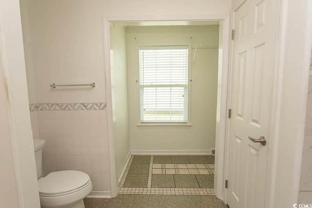 340 Walden Lake Rd, Conway, SC 29526 - bathroom featuring tile patterned floors, toilet, tile walls, baseboards, and a wainscoted wall