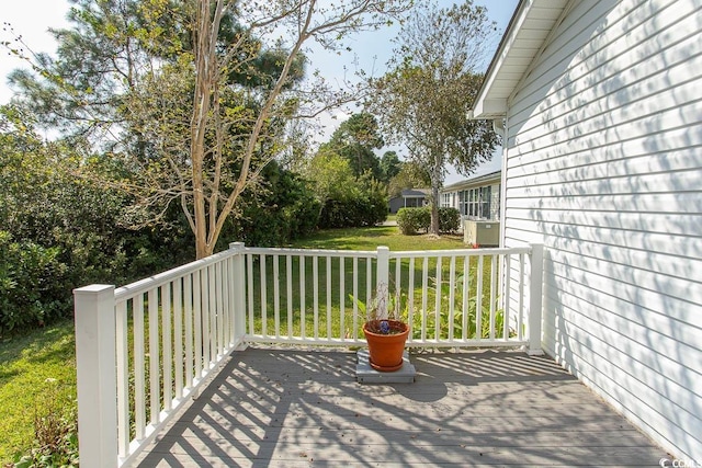 wooden terrace featuring a yard