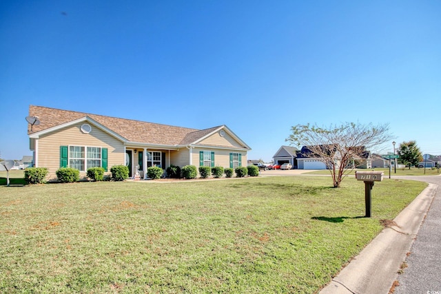 ranch-style home with a garage and a front lawn