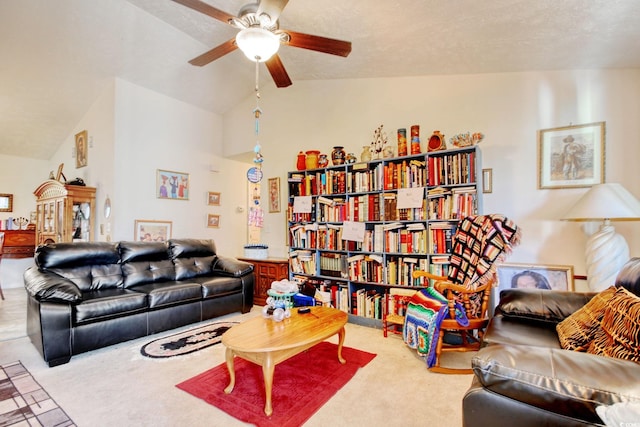 living room featuring carpet, lofted ceiling, ceiling fan, and a textured ceiling