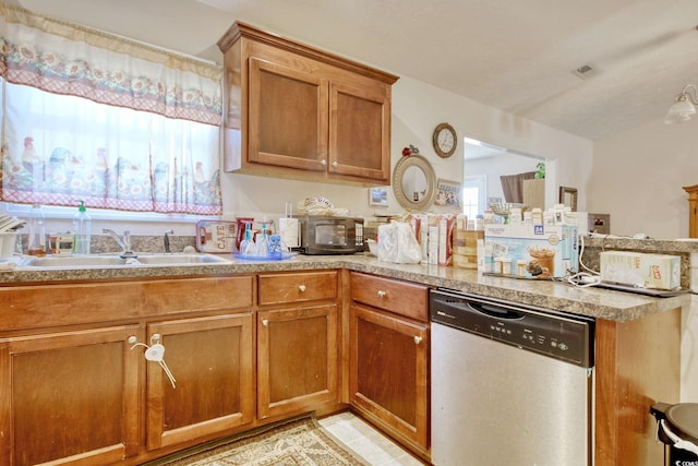 kitchen featuring light tile patterned floors, dishwasher, and sink