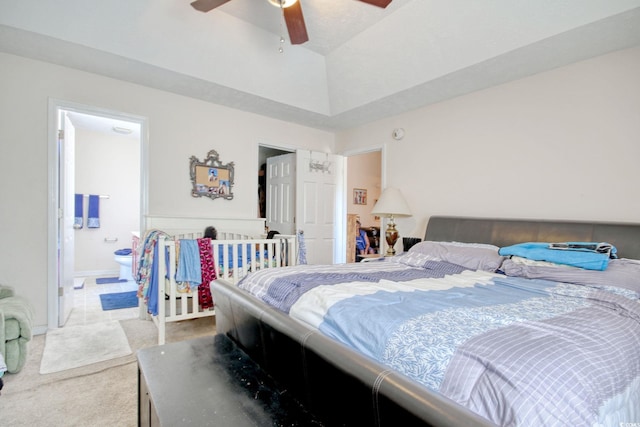 carpeted bedroom with ensuite bath and ceiling fan