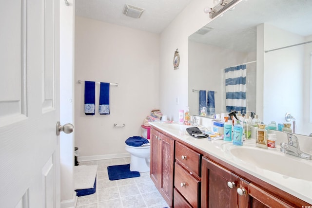 bathroom featuring vanity, a textured ceiling, walk in shower, toilet, and tile patterned floors