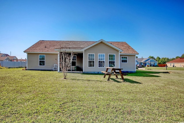 rear view of property with a yard