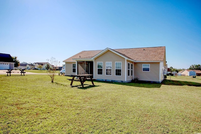 rear view of property featuring a yard