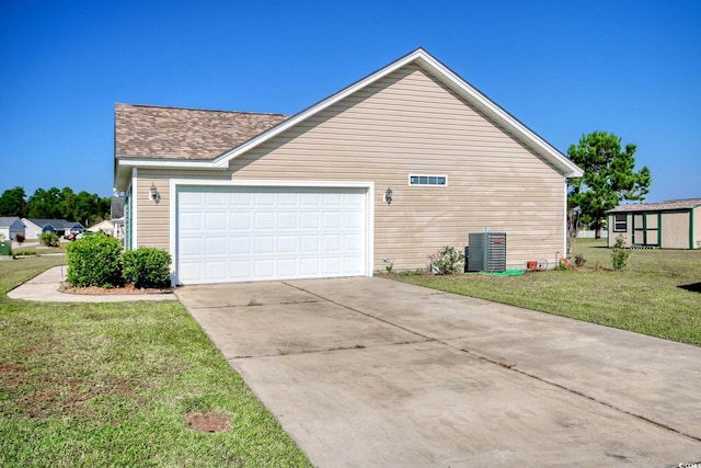 view of home's exterior with a garage, cooling unit, and a yard