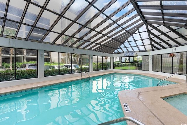 view of pool with glass enclosure