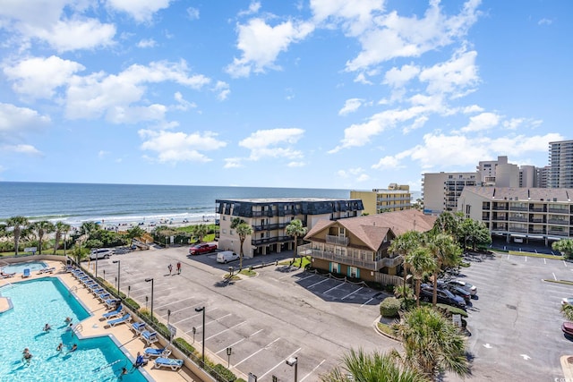 drone / aerial view featuring a water view and a view of the beach