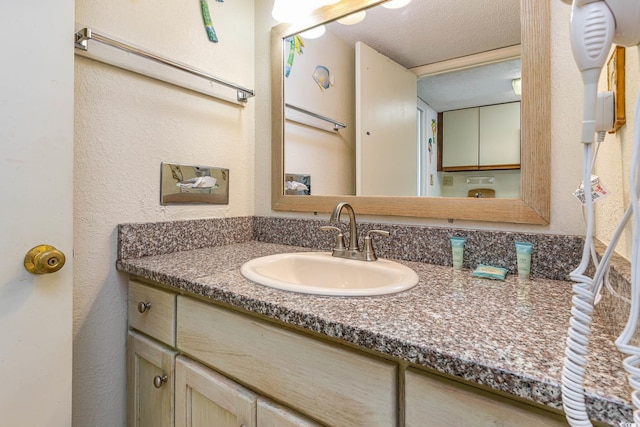 bathroom featuring vanity and a textured ceiling