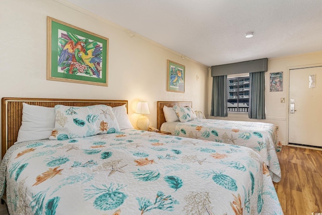 bedroom featuring hardwood / wood-style flooring and crown molding