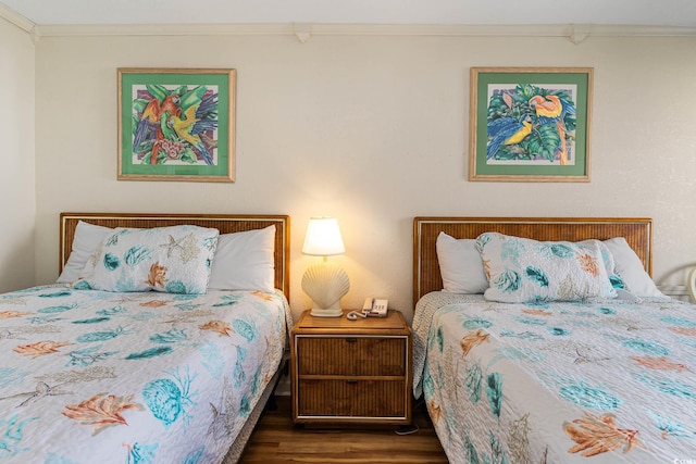 bedroom featuring crown molding and hardwood / wood-style flooring