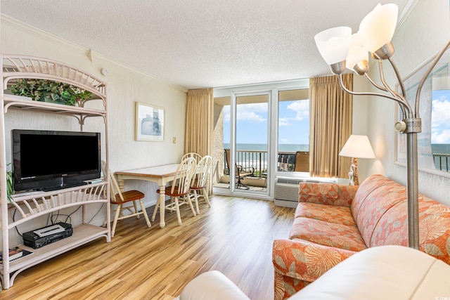 living room featuring a water view, crown molding, hardwood / wood-style flooring, and a textured ceiling