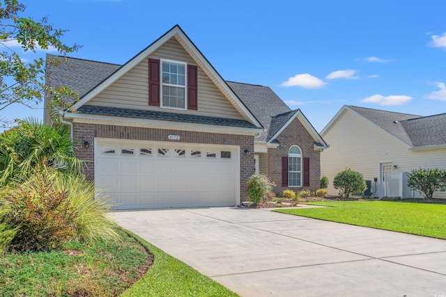 view of front of property with a garage and a front lawn