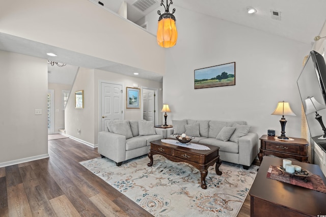 living room with high vaulted ceiling and hardwood / wood-style flooring