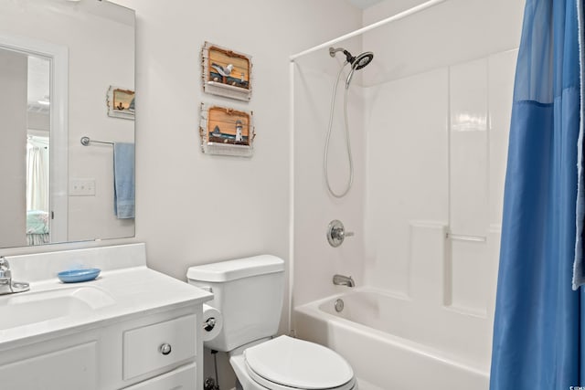 full bathroom with vanity, shower / tub combo with curtain, and toilet