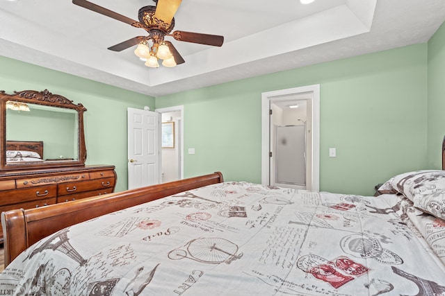 bedroom with a tray ceiling and ceiling fan