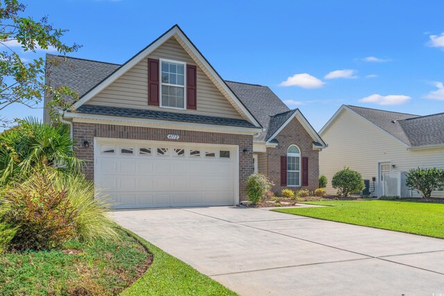 view of front facade featuring a garage and a front lawn