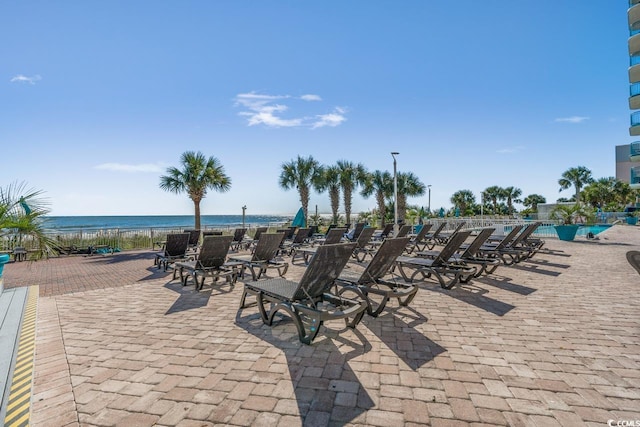 view of patio with a water view