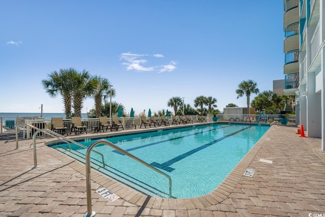 view of swimming pool with a water view