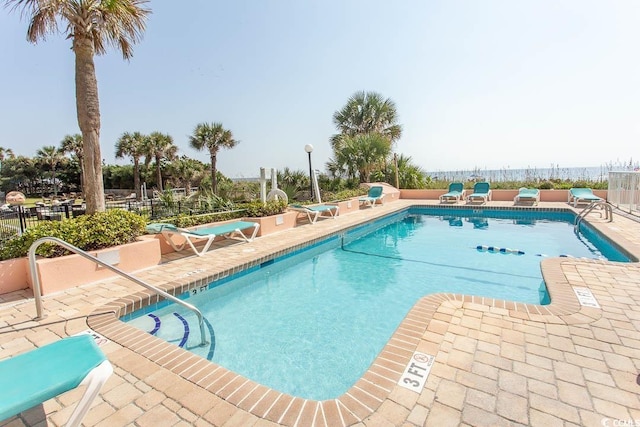 pool with fence and a patio