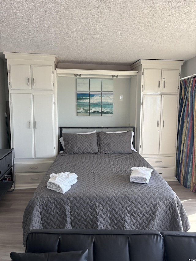 202 70th Ave N Unit 104, Myrtle Beach, SC 29572 - bedroom with wood finished floors, a textured ceiling, and a closet