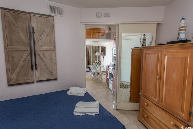 bedroom featuring visible vents and light tile patterned floors