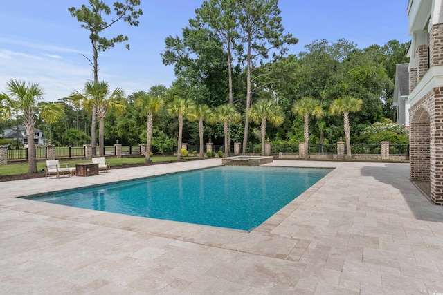 view of swimming pool featuring an in ground hot tub and a patio area