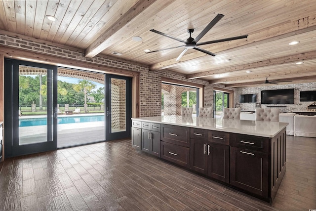 kitchen with wooden ceiling, brick wall, and dark hardwood / wood-style flooring