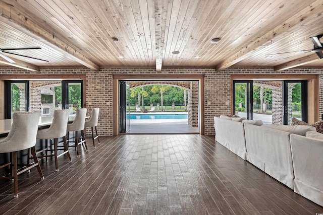 living room with wood ceiling and brick wall