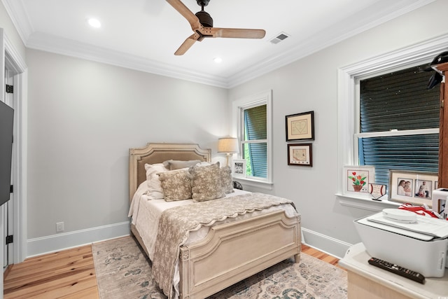 bedroom featuring ornamental molding, ceiling fan, and light hardwood / wood-style floors