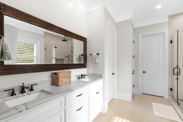 bathroom featuring walk in shower, vanity, and crown molding