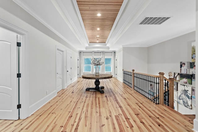 hallway with light wood-type flooring, wood ceiling, a notable chandelier, a tray ceiling, and ornamental molding