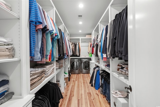 walk in closet featuring independent washer and dryer and light wood-type flooring