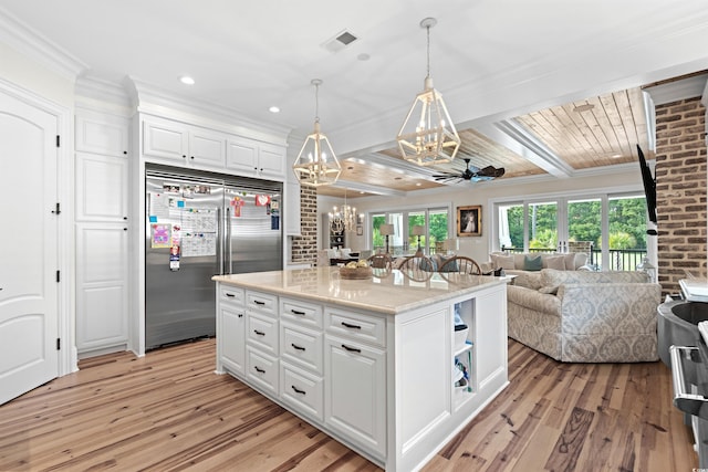 kitchen with a kitchen island, ceiling fan, built in fridge, white cabinetry, and light hardwood / wood-style flooring