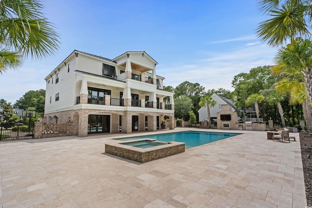 view of swimming pool with an in ground hot tub and a patio area