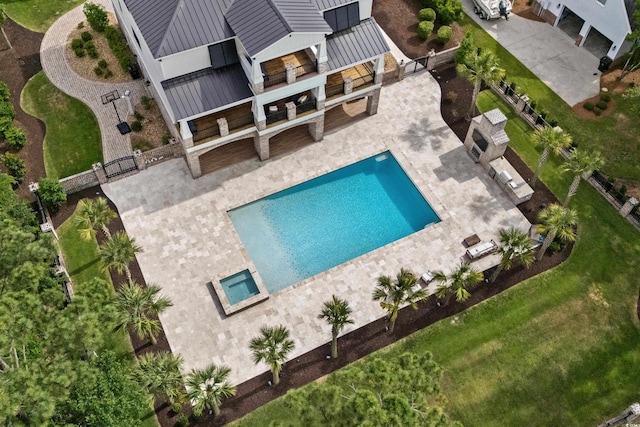 view of swimming pool featuring a patio and a lawn