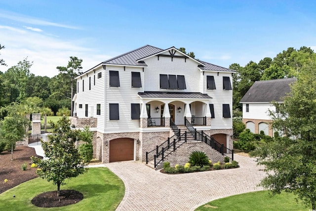 view of front facade with a front yard, a garage, and a porch