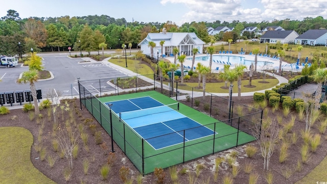 view of sport court featuring a community pool