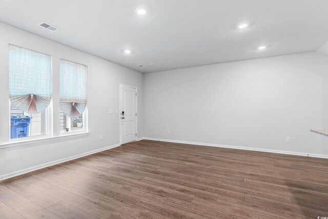 spare room with dark hardwood / wood-style floors