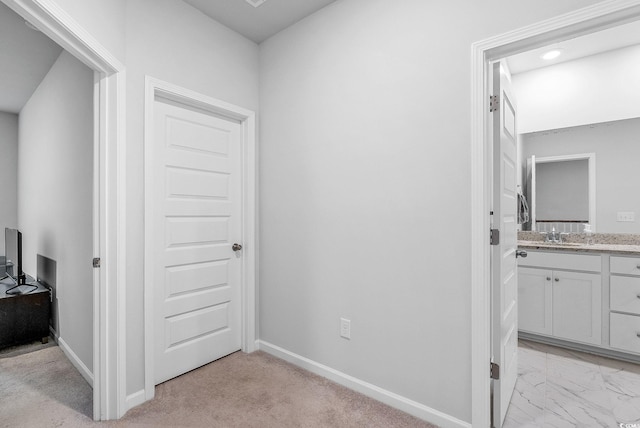 hallway featuring light colored carpet