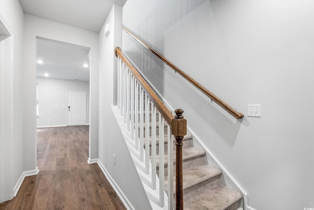 stairs featuring hardwood / wood-style floors